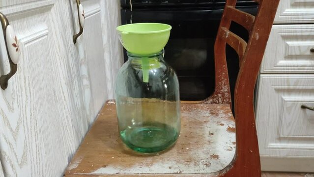 Homemade moonshine. Cooking moonshine in the kitchen. Process of distillation
