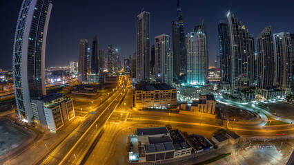 Fototapeta na wymiar Aerial panorama of Dubai Downtown skyline with many towers night to day timelapse.