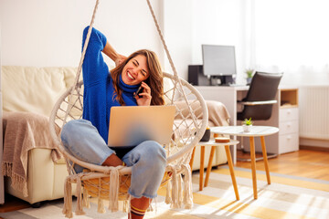 Woman speaking on the phone while working from home