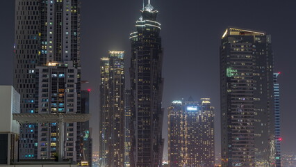 Fototapeta na wymiar Business bay district skyline with modern architecture night timelapse from above.