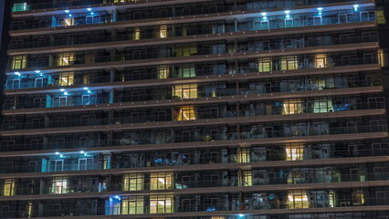 Fototapeta na wymiar Tall blocks of flats with glowing windows located in residential district of city aerial timelapse.