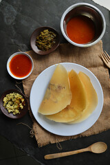 dosa masala. Paper Masala dosa is a South Indian meal served with sambar and coconut chutney over fresh banana leaf.