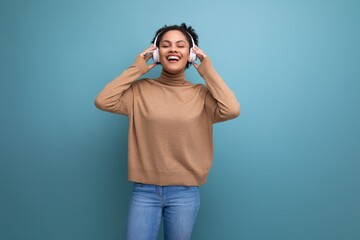 isolated background, cute young brunette hispanic woman freelancer listening to music in bluetooth headphones