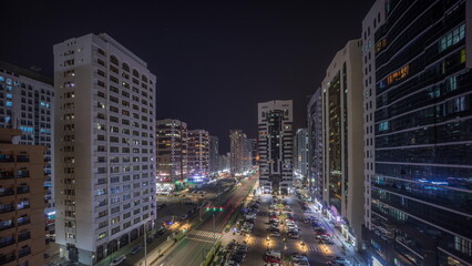 Fototapeta na wymiar Residential buildings and modern city architecture of Abu Dhabi aerial timelapse during all night, UAE.