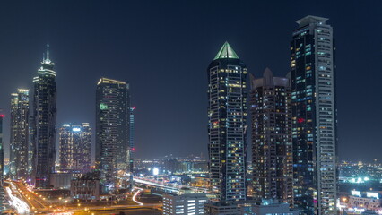 Naklejka premium Business bay district skyline with modern architecture all night timelapse from above.