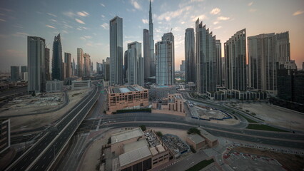Aerial view of Dubai Downtown skyline during sunrise with many towers timelapse.