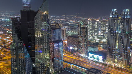 High-rise buildings on Sheikh Zayed Road in Dubai aerial night timelapse, UAE.