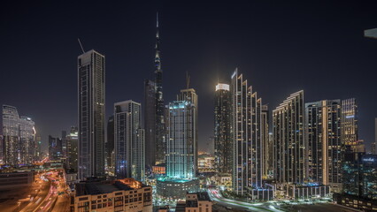 Naklejka premium Aerial view of Dubai Downtown skyline with many towers night timelapse.