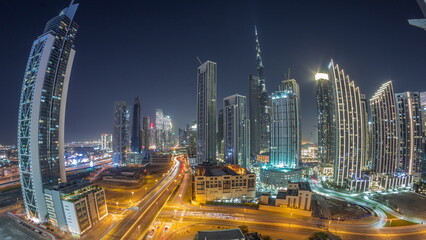 Obraz na płótnie Canvas Aerial view of Dubai Downtown skyline with many towers all night timelapse.