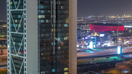 Fototapeta na wymiar Aerial view to Dubai City Walk district night timelapse behind skyscraper from above