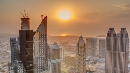 Fototapeta premium High-rise buildings on Sheikh Zayed Road in Dubai aerial timelapse during sunset, UAE.