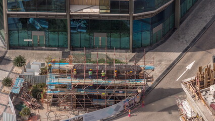 Many workers on the construction site making reinforcement metal framework for concrete pouring...
