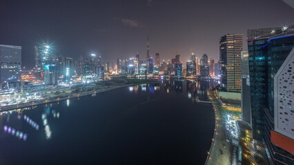 Fototapeta na wymiar Aerial panorama of Dubai Business Bay and Downtown with the various skyscrapers and towers night to day timelapse