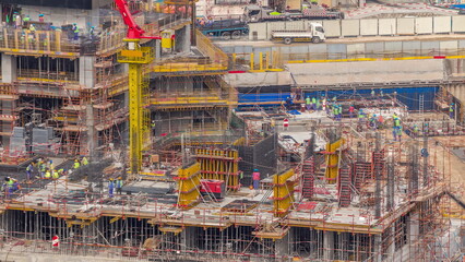 Large construction site with many working cranes timelapse.