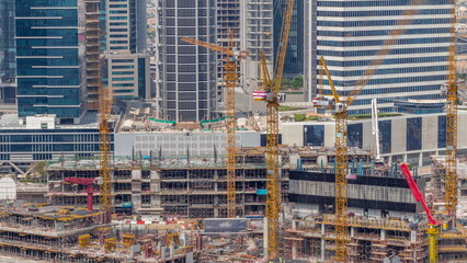 Large construction site with many working cranes timelapse.