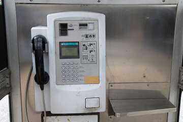 There is an old telephone booth within the residential area, with old public telephones, both of the press button type and with wired telephone receivers.
