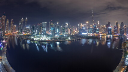Obraz na płótnie Canvas Aerial view to Dubai Business Bay and Downtown with the various skyscrapers and towers night timelapse