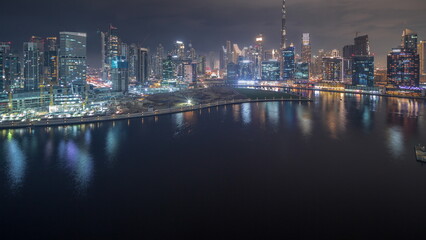Obraz na płótnie Canvas Aerial view to Dubai Business Bay and Downtown with the various skyscrapers and towers night timelapse