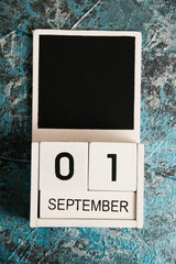 Wooden calendar on a dark background. The date is September 1, the Day of Knowledge.