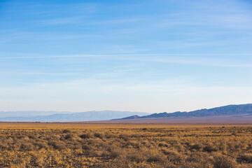 Kazakhstan steppe landscape. Dry grass and mountains
