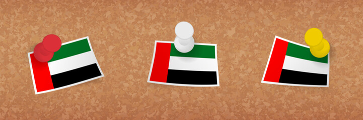 United Arab Emirates flag pinned in cork board, three versions of United Arab Emirates flag.