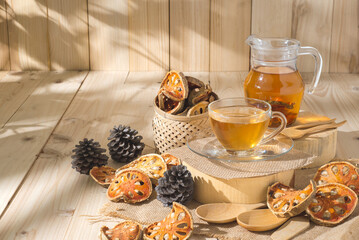Bael Tea glass with dried bael slices on wooden background, juice perfect for detox and relaxation. Refreshing hot bael fruit tea. Tropical delight for healthy lifestyle and exotic flavors
