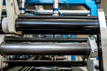 Fototapeta premium The line of assembly of cardboard packaging in boxes and finished products. Mechanism and production industry