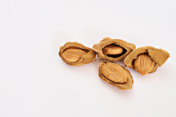 Apricot kernels on a white background. Side view. Vitamin B 17. Healthy food background. There is space for text