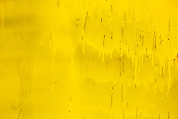 Rusty yellow metal abstract background. Texture of an old plate with dripping stained cracked paint