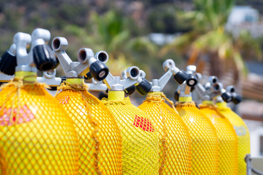 scuba tanks of diving center with air nitrox or trimix in marina port  for courses or dive trips