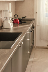 Modern kitchen interior with counter and drawers.