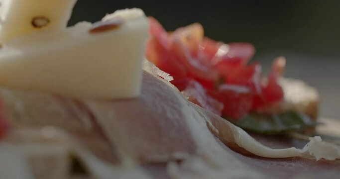 close up of Italian bruschetta with cheese, ham and tomato