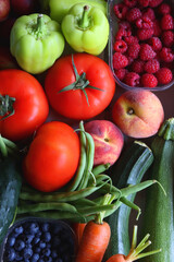 Fototapeta na wymiar Wooden crate full of healthy colorful seasonal fruit and vegetable. Top view.