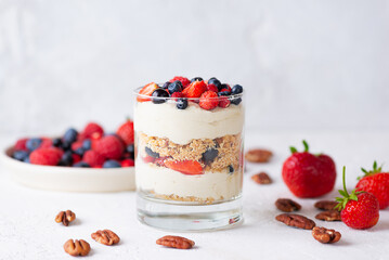 Sweet vegan dessert in a glass with berries, whipped cream and biscuit. Healthy food, sugar, gluten and lactose free.