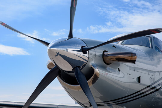 Detail of the nose cone, blades, spinner, intake, and exhaust of a turboprop Pilatus PC-12. 
