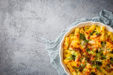 Pasta baked with broccoli and chicken. Broccoli, cheese and gratin sauce on baked penne pasta.