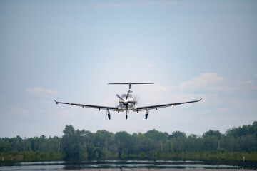Fototapeta na wymiar A Pilatus PC-12 taking off from a regional airport in Canada