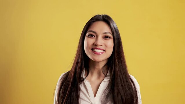 Asian Girl in a studio thinking and having an idea - extreme slow motion shot