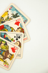 Intricate vintage playing cards scattered on the table.