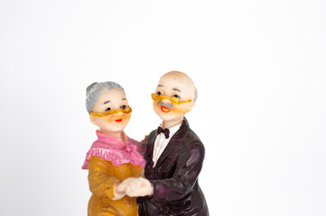 Elderly couple statuette on a white background