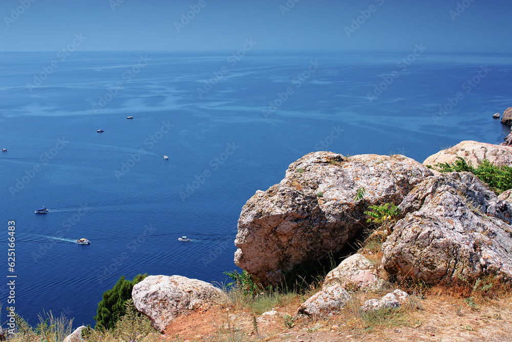 Wall mural beautiful landscape with rock cape and ship sailing sea