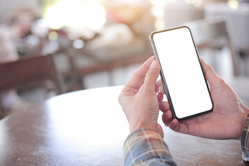 cell phone blank white screen mockup.hand holding texting using mobile on desk at office.background empty space for advertise.work people contact marketing business,technology