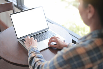 computer screen blank mockup.hand woman work using laptop with white background for advertising,contact business search information on desk at coffee shop.marketing and creative design