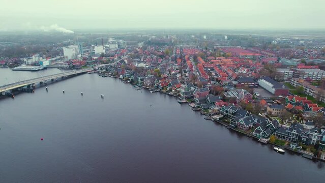 Town Koog aan de Zaan seen from the bird's eye view. Town by the river concpet. High quality 4k footage