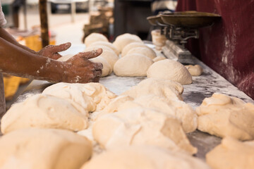male hands knead yeast dough for baking bread