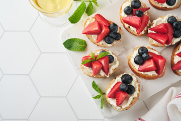 American flag sandwich with strawberries, blueberries, whipped sweet cream, soft cheese on toast bread. 4th of July American Independence Day food. Independence or Patriotic Day breakfast idea Mock up