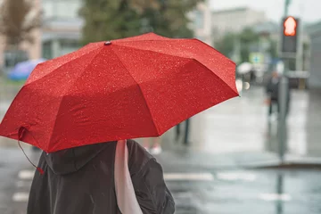 Tuinposter Abstract girl under red umbrella, modern city, rainy evening © svetlanais