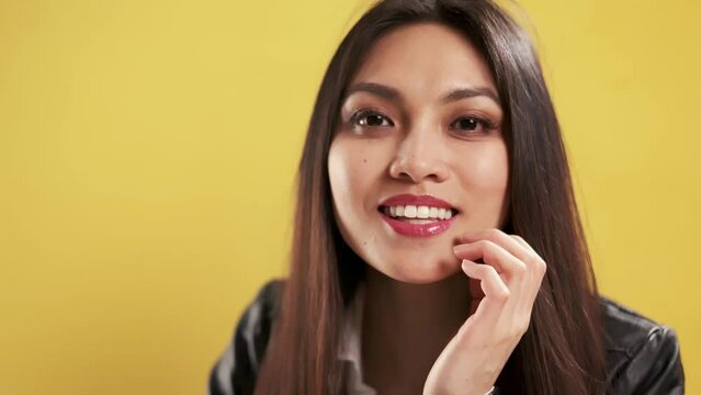 Close up shot of an Asian Beauty in a studio - extreme slow motion shot