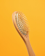 Wooden eco friendly comb for hair care. Supplies for personal hygiene. - obrazy, fototapety, plakaty