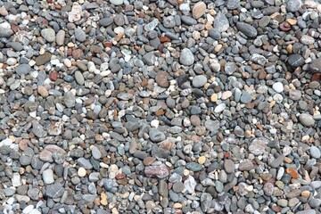 Pebbly beach background from Crete, Greece. Shingle beach.